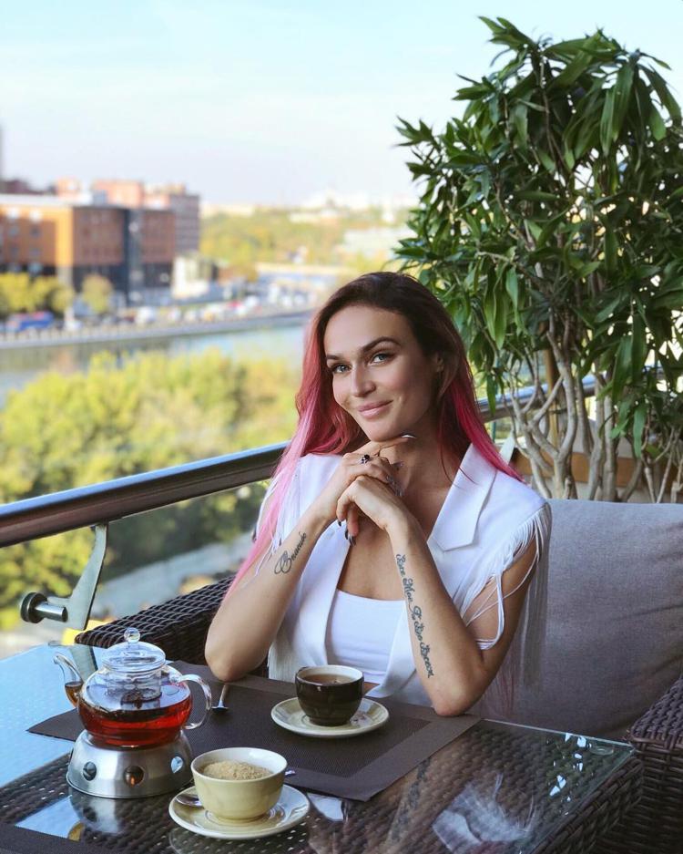 Alena Vodonaeva having a cup of coffee