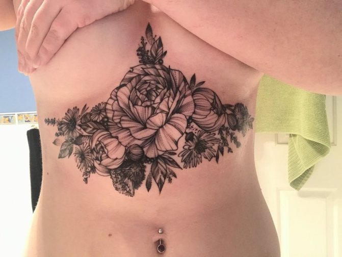 Large tattoo with a rose under her breast