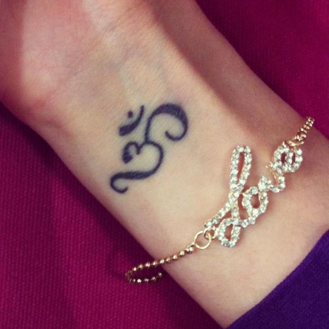 Buddhist amulet tattoo in the form of om sound