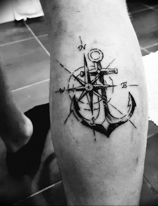 Black and white anchor leg tattoo