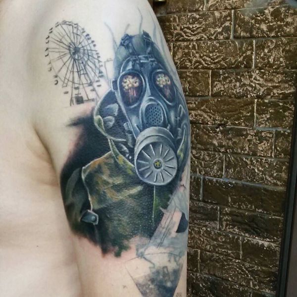 Colored tattoo of a stalker with a gas mask on his shoulder