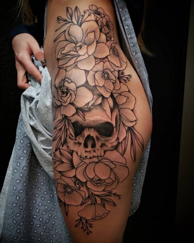 Flowers and skull on the side of the thigh
