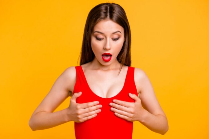 girl holding her breasts