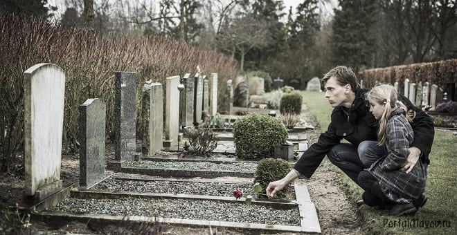 Daughter with her father in the cemetery