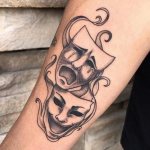 Two masks on a man's arm
