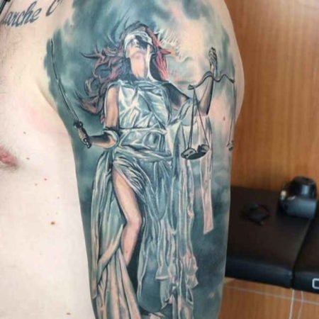 Themis tattoo on the shoulder