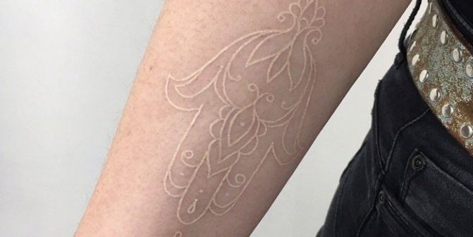 Contour white tattoo on arm