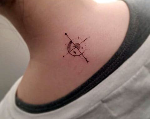 Small tattoo with compass on neck