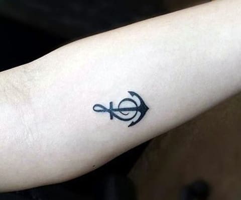 Small tattoo with an anchor on his arm
