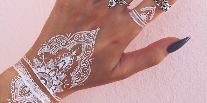 White henna mehendi on hands