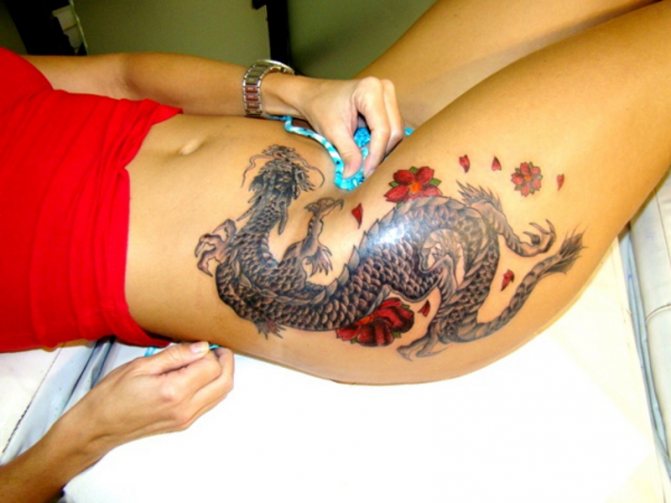 A tattoo in the shape of a dragon looks good on the hip