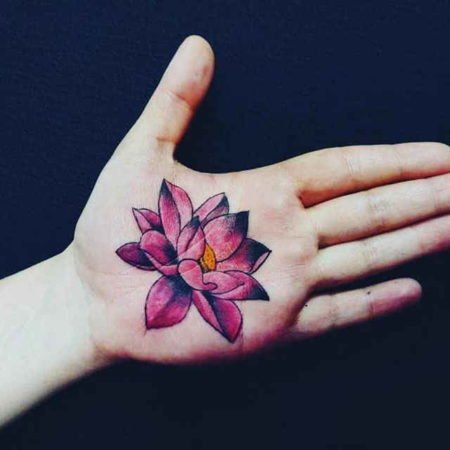 On the palm of the hand tattoo a flower.