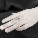 cross tattoo on thumb