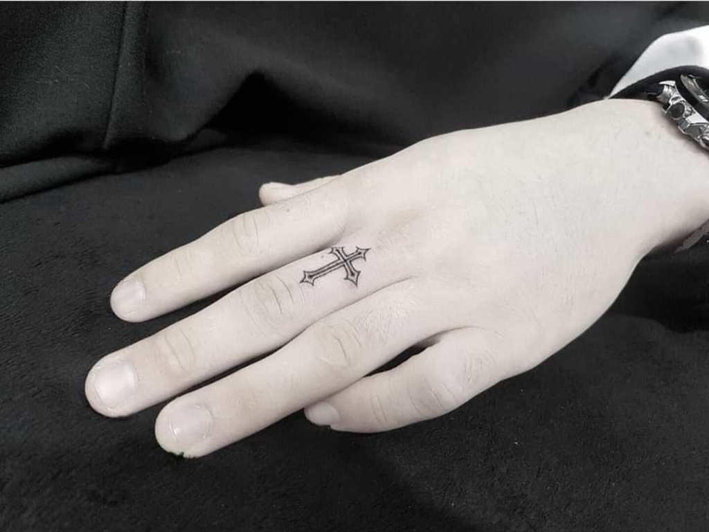 Cross tattoo on the finger