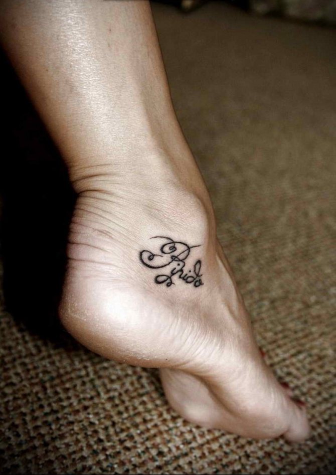 Small tattoo inscription around the ankle
