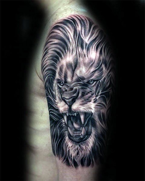 Lion's grin - tattoo on a man's arm