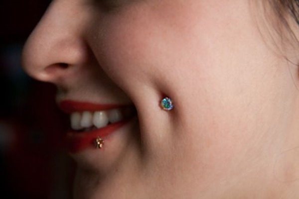 Piercing on the cheek dimples. Photo, types, what is it called