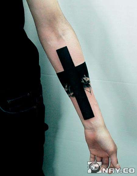 Arm with a black tattoo