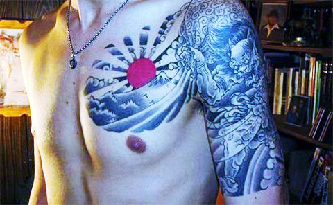 Plot sun tattoo on chest