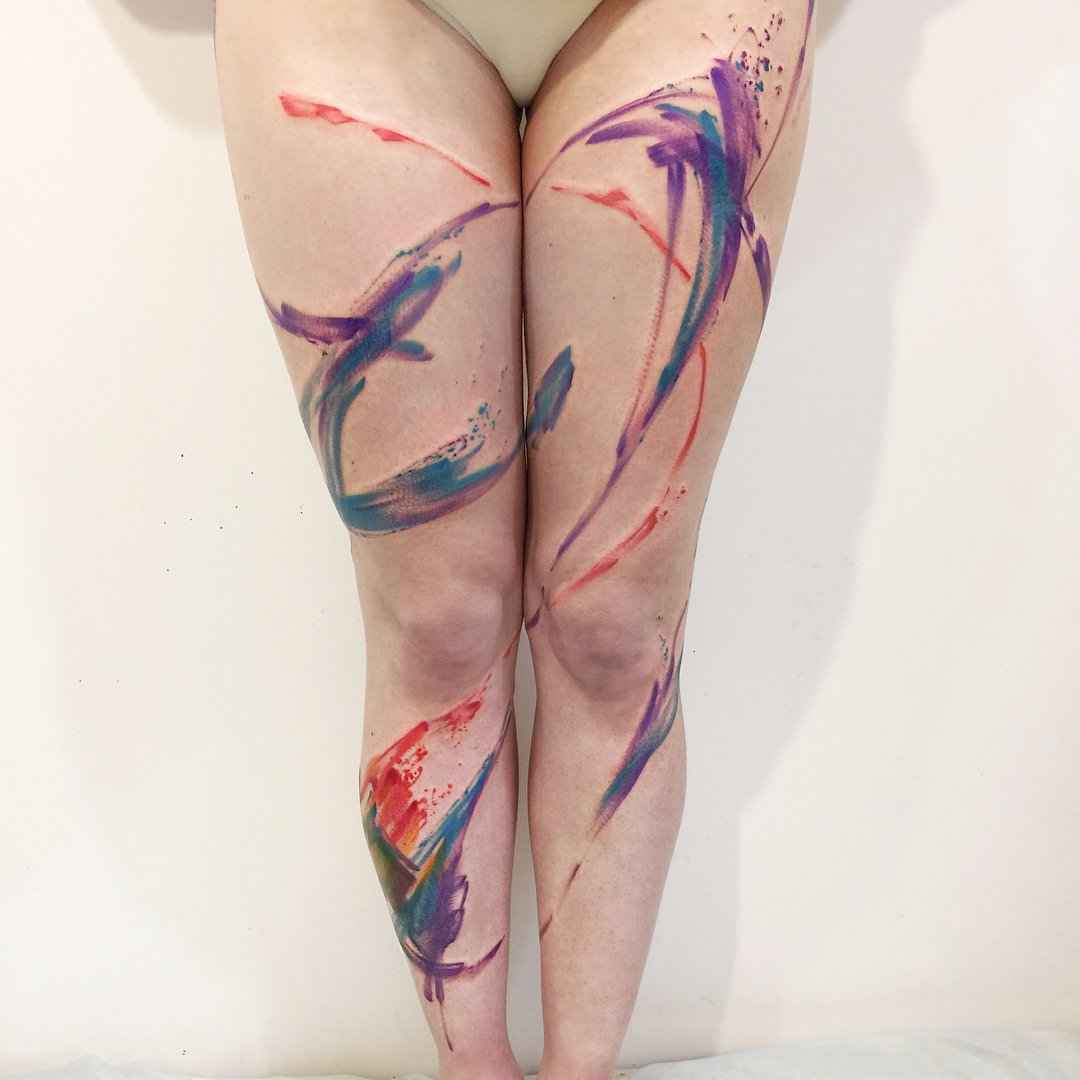 Watercolor abstract tattoo on legs