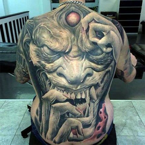 Tattoo of a demon on his back - photo