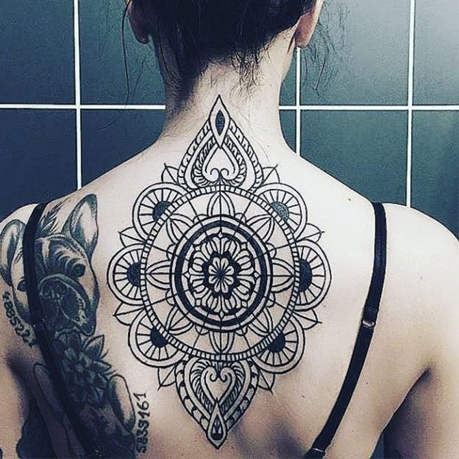 girls tattoo ornamental on her back
