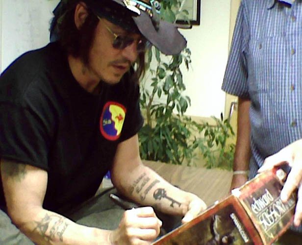 Johnny Depp tattoo. Pictures on his arm, back, hand