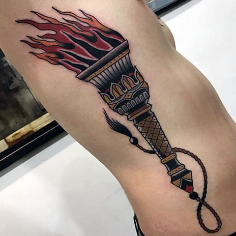 Tattoo torch on his side