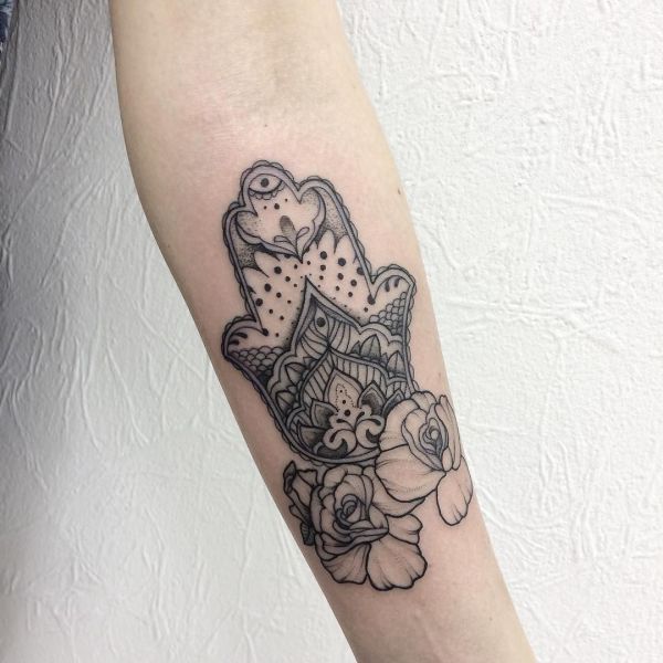 Tattoo of a Hamsa with flowers