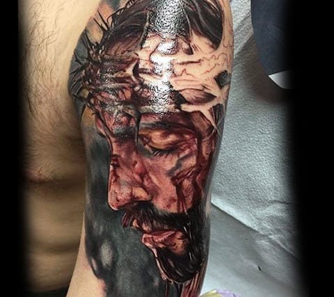Tattoo of Jesus Christ with a crown