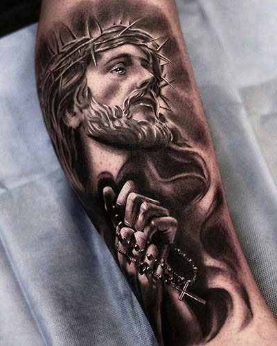 Tattoo of Jesus on arm, back, shoulder, chest. Meaning, on the cross, with the devil, machine gun, dove