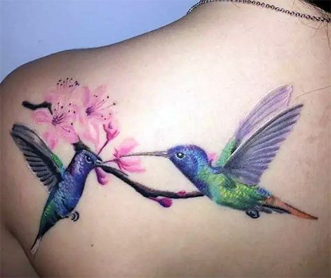 Tattoo of a hummingbird on a girl's back