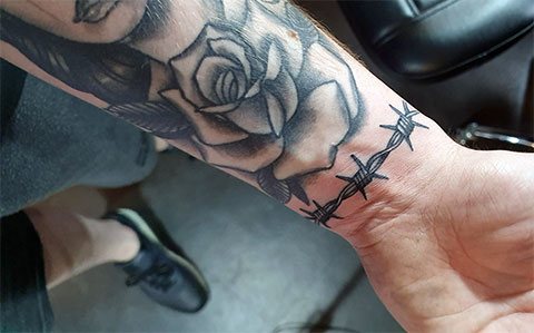 Barbed wire and rose tattoo