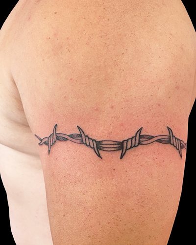 Barbed wire tattoo. Meaning on the foot, wrist, neck, leg, with flowers, rose, heart, cross