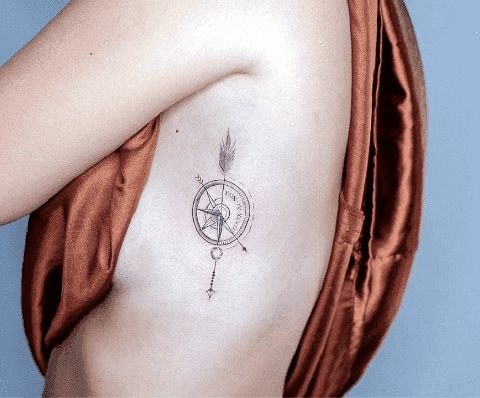 Tattoo compass on the side of a girl