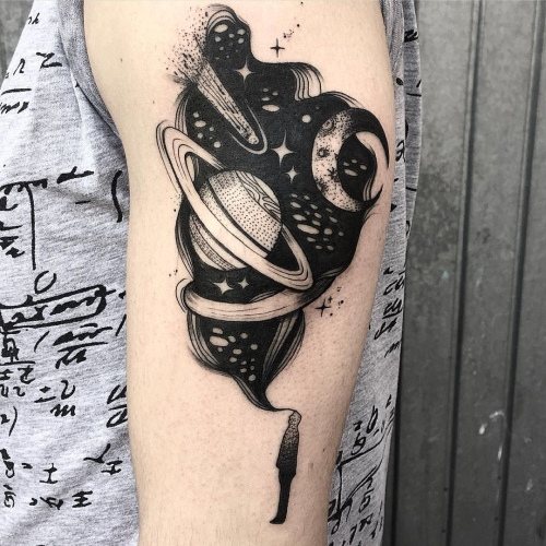 Tattoo planet on your arm, forearm, leg. Sketches of black and white, minimalism, geometry. Photo