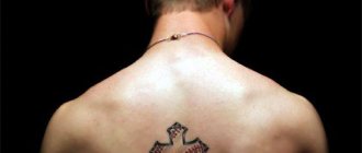 Tattoo of a cross on back