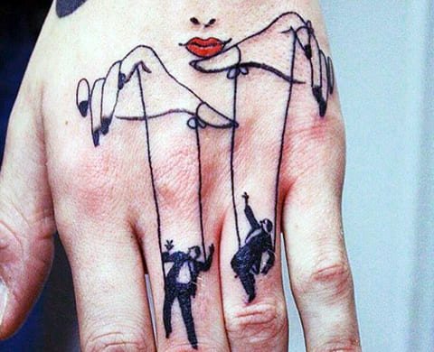 Tatuaggio di un burattinaio e burattini sulla mano