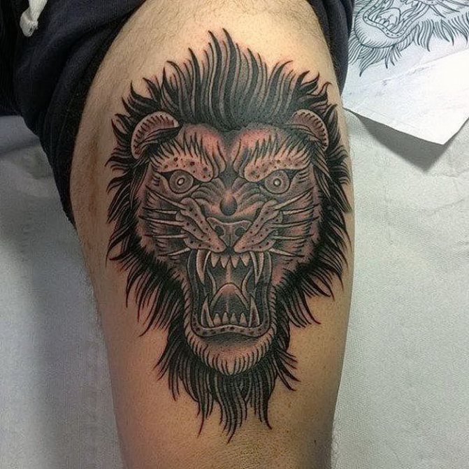 Blackwork lion tattoo on thigh