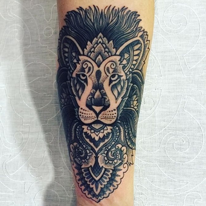 Blackwork lion tattoo with forearm ornaments