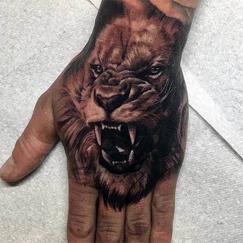 Tattoo of a lion - a male tattoo on his arm