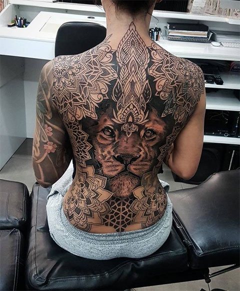 Tattoo of a lion on a girl's back