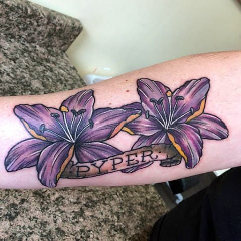 Tattoo of a lily on forearm