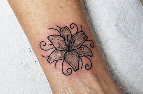 Tattoo of a lily on the wrist