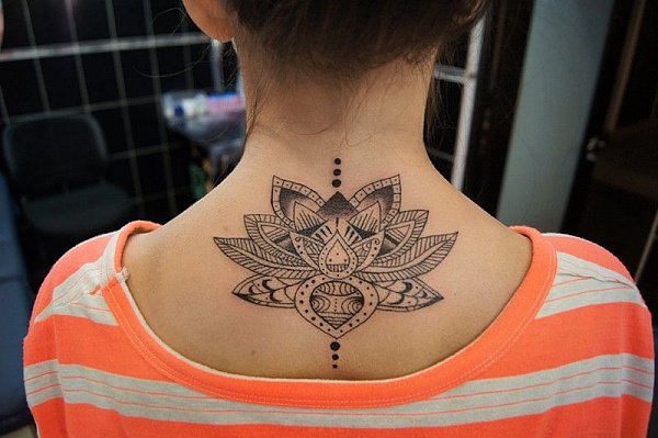 Lotus tattoo on the back near the neck