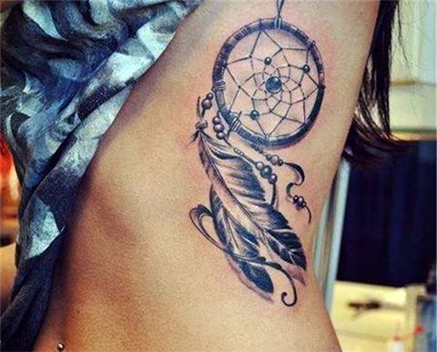 Tattoo dream catcher on a girl's side
