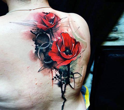 Tattoo of a poppy on her shoulder blade