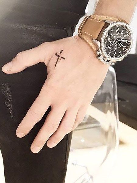 Tattoo of a small cross