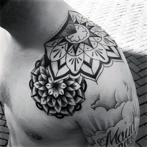 Tattoo mandalas in dvorak style on a man's shoulder