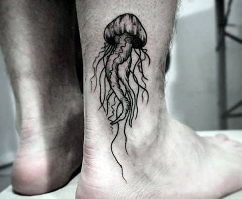 Jellyfish tattoo on a man's leg - photo